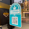 New York State licensed cannabis dispensary verification badge with QR code on storefront