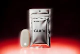 Curv by Bloom silver metallic pouch and white device on red gradient background