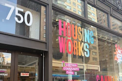 Housing Works storefront at 750 with pink signage, LGBTQIA+ community care messaging, and cannabis dispensary window display on urban street