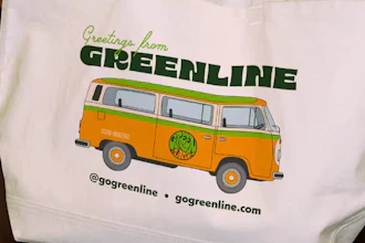 GO Greenline vintage bus tote bag with orange and green retro van graphic and contact information
