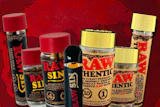 RAW premium smoking products collection including rolling papers, hash holders, and accessories displayed on red background